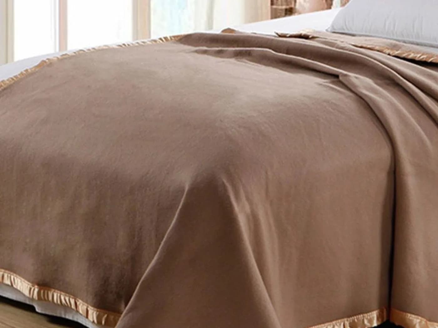 Decorative bed runner and throw styled on a hotel bed