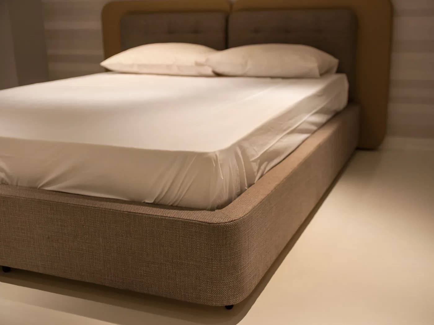 White fitted sheet securely covering a hotel mattress