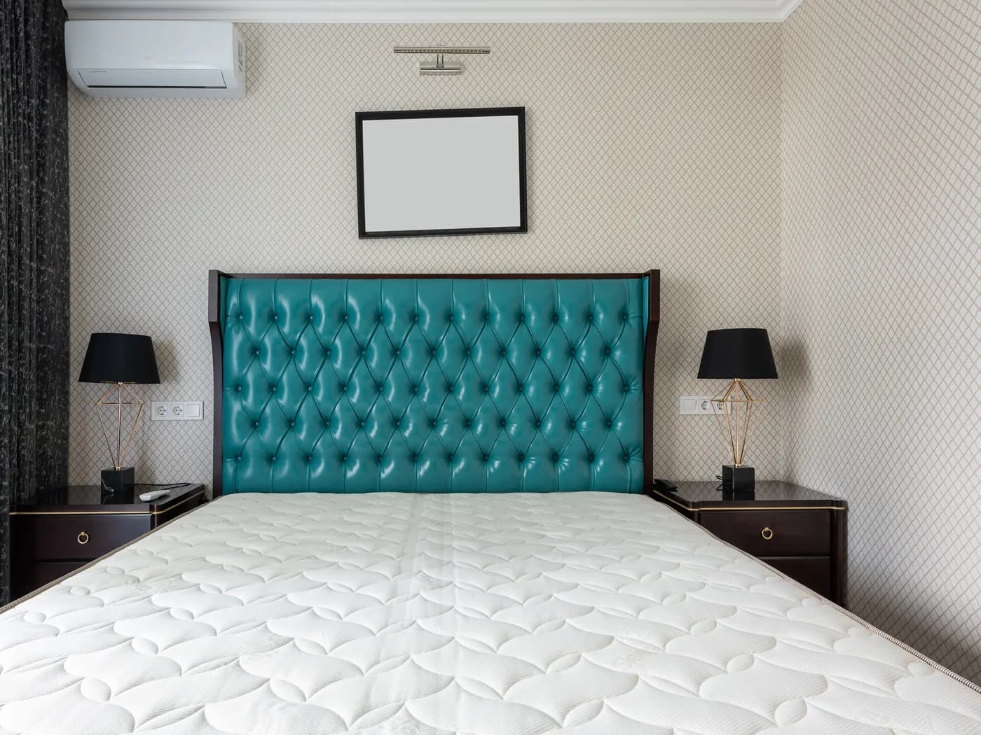 Quilted mattress protector fitted to a hotel bed